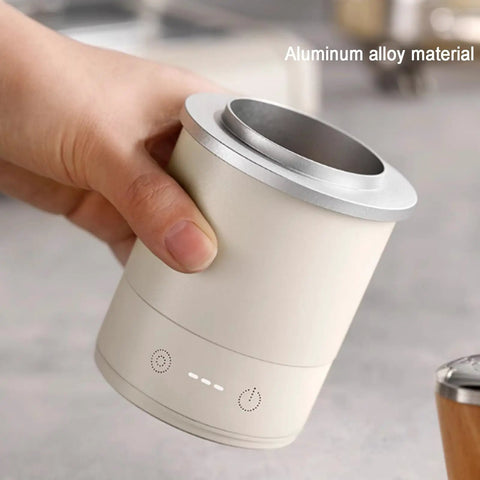 Hand holding the Total Game Changer Aluminum Coffee Dosing Cup And Espresso Digital Scale Combo, showcasing aluminum material and design.