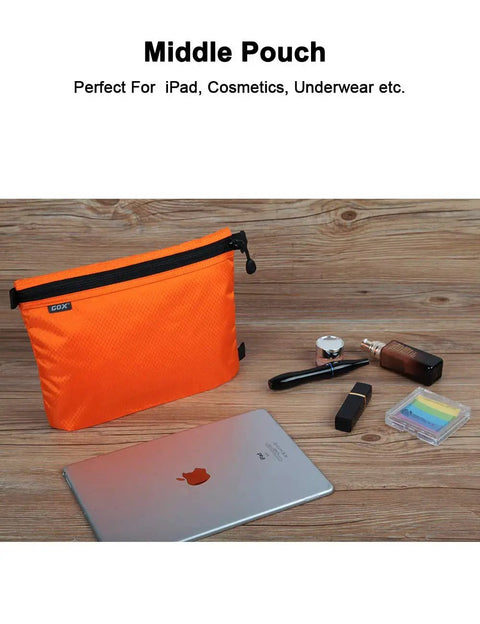 Middle pouch of the Three Pack Travel Toiletry Bags for Men Carry-On Organizer Pouch Set, shown with iPad and cosmetics, in orange.