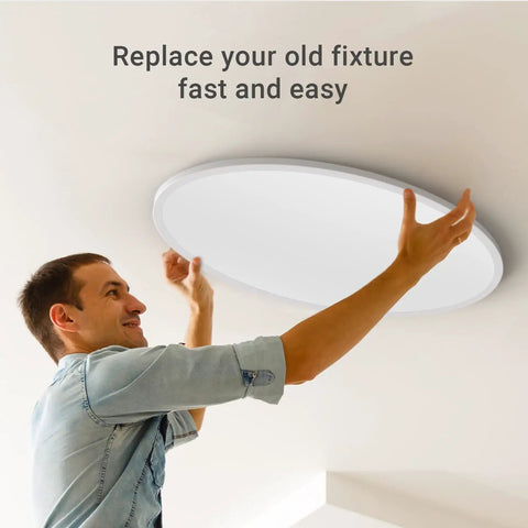 Man installing 32 Inch Slim Oval Led Ceiling Light Fixture 50W Ultra Bright 3500 Lumen Dimmable Adjustable Color Temperature 2700K 4000K
