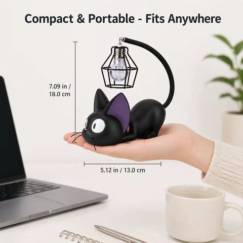 Jiji Black Cat Night Light Inspired by Kiki's Delivery Service, cozy resin desk lamp, compact size held in hand, laptop nearby
