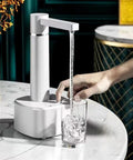 Desktop Water Dispenser With Hot And Cold Water, Three Level Volume Control, USB Charging, on table dispensing water into a glass