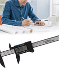 YUEHISY Digital Caliper Mini LED 0 100mm Plastic Lightweight Portable measuring item on paper, showing 0.16 mm reading.