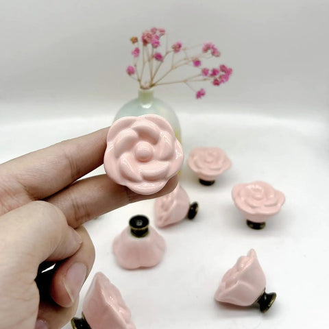 Grab This Dope 10 Piece Set Of Pink Rose Porcelain Cabinet Knobs Perfect For Dressing Up Drawers And Dressers. 1.4 Inch Ceramic flower handle held in hand.