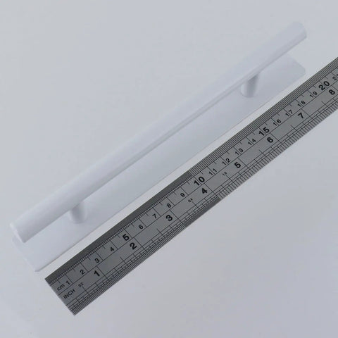 Two Pack Stick On Cabinet Handles Seven Point Eight Inch White No Drill Installation With Ultra Strong Adhesive Tape next to ruler