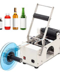 Smooth Operator Semi Automatic Round Bottle Labeler with blue roll, labeling bottles from 12 to 150 mm swiftly.