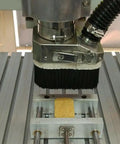 Workhorse Grade Cnc Router Dust Shoe With 80 Mm Nylon Brush and Bulletproof Vacuum Seal, mounted on CNC machine for precise dust control.