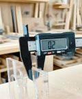 Two Piece 15 In One Acrylic Router Templates For Woodworking With Heart Inlay Template And Circle Template Jig Drawing Cut Guide Pro Grade Inlay Tools And Accessories Set For DIY Wood Projects shown with caliper measuring 0.2 inch thickness in workshop setting.