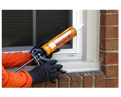 Close-up of Heavy Duty Black Caulk Sealant being applied with a gun at a window joint for weatherizing moving joints.