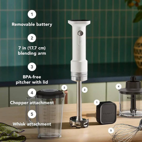Cordless Hand Blender With Battery Included And Removable Blending Arm Features stainless steel blades and whisk attachment on kitchen counter.