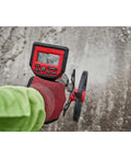 Rugged 12 Inch Digital Measuring Wheel With IP54 Backlit Display used to measure distance on gravel surface.