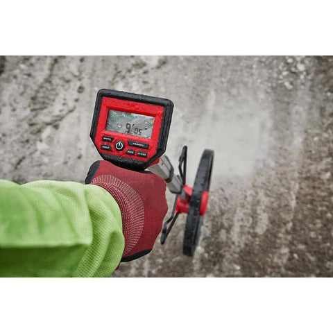 Rugged 12 Inch Digital Measuring Wheel With IP54 Backlit Display used to measure distance on gravel surface.