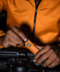 Close-up of hands using Torque Screwdriver And Driver Set For Maintenance And Bike Repair Ten To Seventy Inch Pounds Range T Bar Handle Forty Bits Including Phillips Pozidriv Slotted Hex Torx One Quarter Inch Socket Shaft Extension Orange with bike equipment.