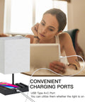 Two Pack Bedside Lamps With Wireless Charging, USB A And USB C Ports, And AC Outlet next to woman using tablet