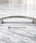 Curved Arch Cabinet Pulls Zinc Handle Bar 5.5 Inch Length With 5 Inch Center To Center Mounting Brushed Nickel Finish on marble surface