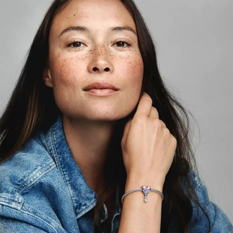 Woman wearing Birthday Hot Air Balloon Charm For Moments Bracelet In Sterling Silver With Multicolor Enamel Finish Gift Box Included Women Jewelry Gift Totally Cute Birthday Accessory For Her, showing charm details.
