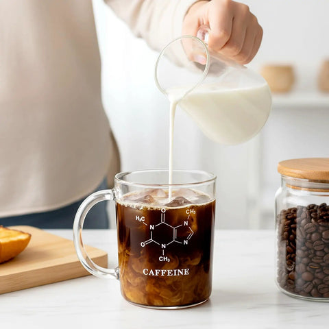 Pouring milk into Two Pack Beaker Mugs With Handles, 16 Oz Caffeine Molecule Glass Coffee Cups, Clear Borosilicate Graduated Beaker Mugs for tea, latte, hot or cold drinks