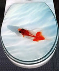Premium Toilet Seat With Slow Close Brushed Nickel Hinges And Scratch Resistant Finish showing a goldfish design on the lid.