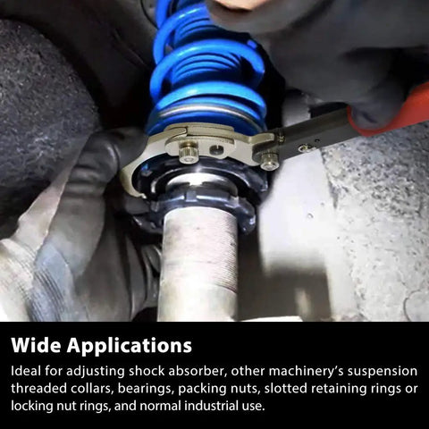 View of 11 Piece Hook And Pin Spanner Wrench Set With Changeable Heads From 3/4 To 6 1/2 Inch For Suspension Coilover Nut And Collar Adjustments Pro Grade Heavy Duty Carbon Steel Tool Kit in use, adjusting suspension coilover with gloves.