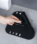 Hair Stopper Shower Drain Strainers Silicone Adjustable, A in large black silicone, showing letters being peeled off.