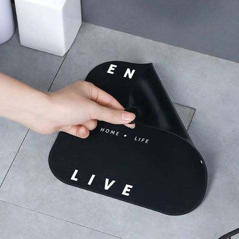 Hair Stopper Shower Drain Strainers Silicone Adjustable, A in large black silicone, showing letters being peeled off.