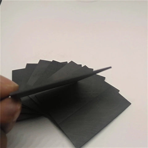Person holding High Temperature Graphite Plate For Pyrolysis Block Anode Anti Corrosion Heat Sink 100x50x2mm 5 Pieces set