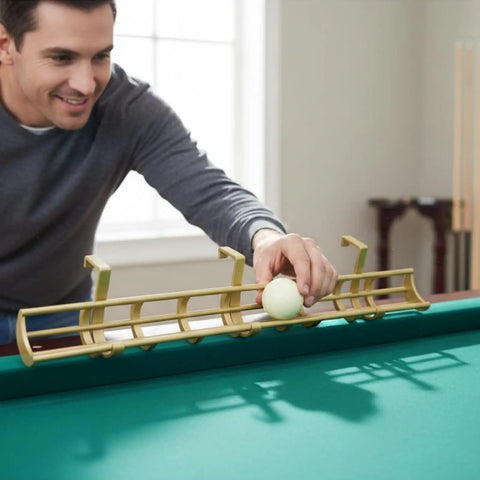 Man using Solid Gold Billiard Ball Rack And Pool Organizer Tray Wall Mount Storage Holder to place a ball on a pool table.