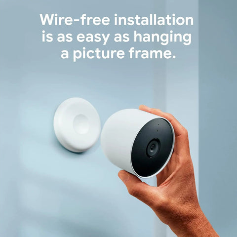 Person installing Nest Cam Outdoor Or Indoor Battery 2nd Generation 2 Pack with Extra Replacement Cable, demonstrating easy setup.