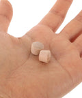 Two khaki Wooden Screw Hole Plugs 50 Pcs With Natural Finish Reusable Sturdy Wood Plugs for DIY on a hand