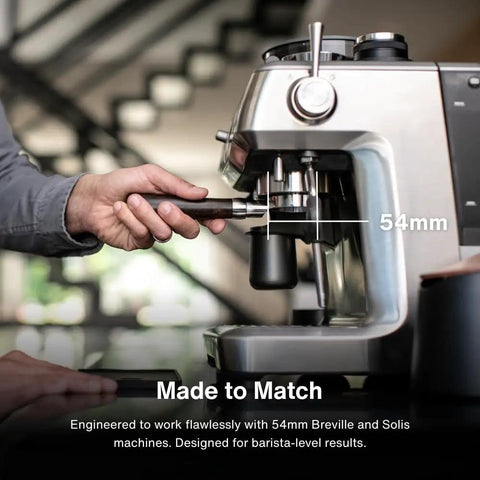 54mm Bottomless Naked Portafilter For Breville 54mm Machines With Olivewood Handle Includes Double Shot Filter Basket See The Shot In Real Time And Dial In Your Espresso Like A Pro Home Barista being inserted into Breville machine.