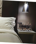 Vintage Steam Locomotive Model Sculpture for Desk Decor and Living Room on a nightstand beside a bed under a lamp