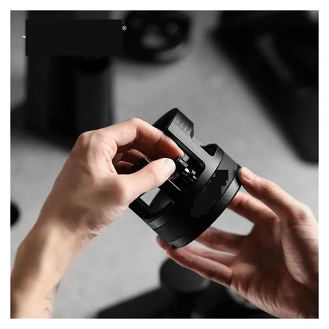 Person adjusting the 58mm Dosing Funnel And Coffee Distributor For Espresso Portafilter Holder with adjustable tamper.