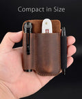 Hand holding compact full grain leather pocket organizer, chestnut color, with knife holder and pen loop, everyday carry.