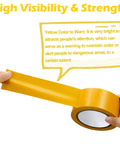 Hands holding yellow 2-inch wide floor tape, part of 9 Roll Floor Marking Tapes Pack, 2 Inch Wide by 100 Feet Yellow Durable Non Abrasive PVC Safety Tape.