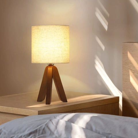Wooden Tripod Table Lamp With Brown Base And Linen Fabric Shade on nightstand, space saving light for bedroom, cozy ambience