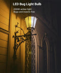 Outdoor wall-mounted lantern with 4 Pack Dusk To Dawn Outdoor LED Bulbs 9W 60W Equivalent glowing in 2000K amber light at night.