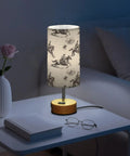 Cowboy Watercolor Decor Bedside Lamp With 3-Way Dimmable Touch Control And Built-In Charging Station next to vase and book on nightstand