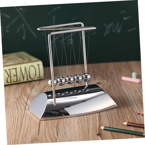 Z Shape Newtons Cradle Desk Toy For Home Office Decor Five-ball silver pendulum on wooden desk with chalkboard and books