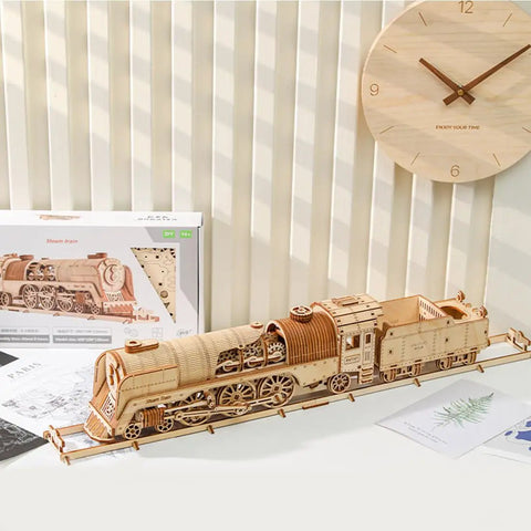 3D Wooden Steam Train Building Set For Adults With Wind Up Mechanical System displayed on a shelf with packaging