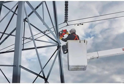 Tough As Nails Lineman Magnetic Drill Kit Featuring Self Powered Magnet Base in use, drilling steel structure at height.