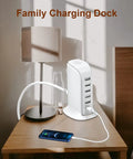 40W USB Charging Hub Workhorse With Five Ports And Type C 3A Desktop Wall Charger Tower on nightstand next to phone and lamp