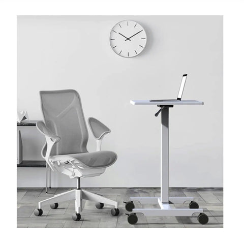 Fully Adjustable Rolling Laptop Stand With Rugged Aluminum Frame Convertible Standing Desk Tray next to modern office chair.