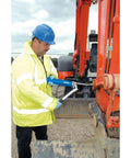 Worker uses Heavy Duty 500 CC Lever Grease Gun For Bulk Or Cartridge Loading on industrial equipment, hydraulic connector visible.