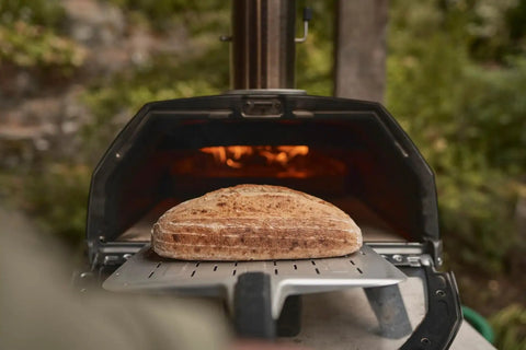 Bread baking in Karu 2 Pro Multi Fuel Pizza Oven For Backyard Grilling Wood Or Gas Fired 16 Inch Stone Pizza Maker