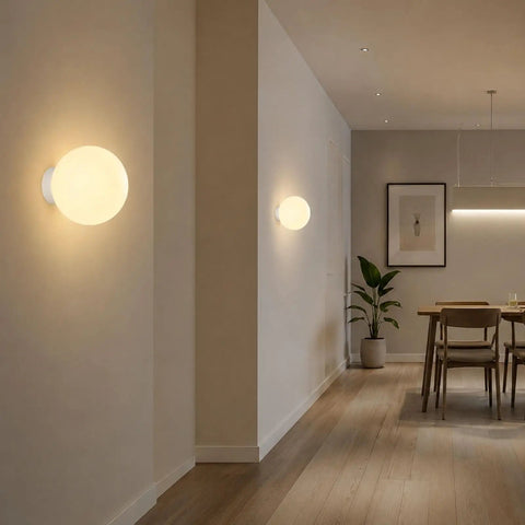 Minimalist Globe Wall Sconce, 1-Light White E27 Round Wall Light Fixture illuminating a modern hallway with soft light.