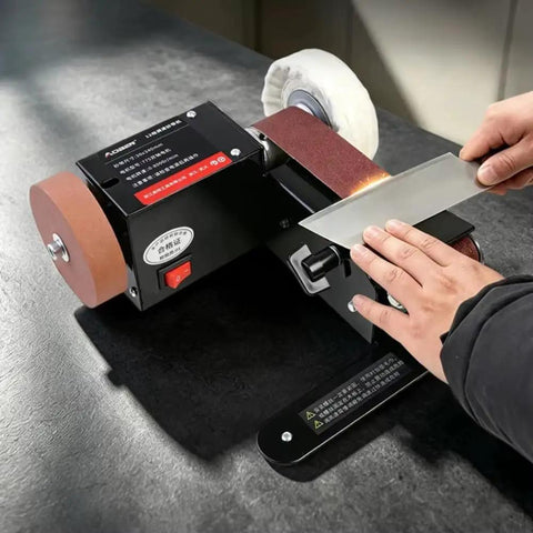 Badass Compact Desktop Electric Belt Sander Set For Sharpening Knives with an adjustable speed setting on a workbench.