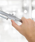 Rock Solid Eight Inch Stainless Scribe Calipers With Replaceable Carbide Tip measuring a screw, showcasing dual scale readouts.