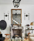 Classic Rustic Double Wall Sconce Lighting Fixture With Flared White Textile Shade And Black Long Arm For Bedroom Bathroom And Hallway displayed in a living room setting above a fireplace.