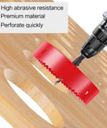 Angled view of a 4.5-inch red hole saw with arbor on a drill cutting plywood.