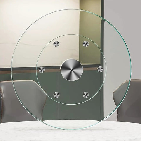 Game Changer Lazy Susan Serving Tray With Whisper Smooth Tempered Glass Top and Beefed Up Aluminum Bearing Base For No Sweat Dining Table Sharing And Hassle Free Entertaining Size Thirty Five Inches Wide, featuring a clear tempered glass top and aluminum bearings.