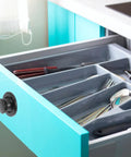 Open drawer with cutlery, featuring Six Pack Embedded Retractable Spring Knobs Zinc Alloy Cabinet Door Pulls Hidden Handle on teal cabinet